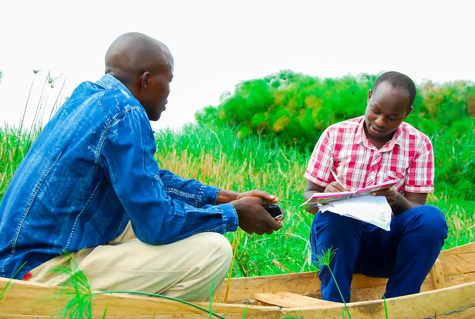 Two MOD team members reviewing notes in the field